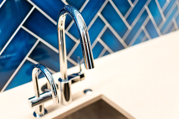kitchen faucet blue backsplash
